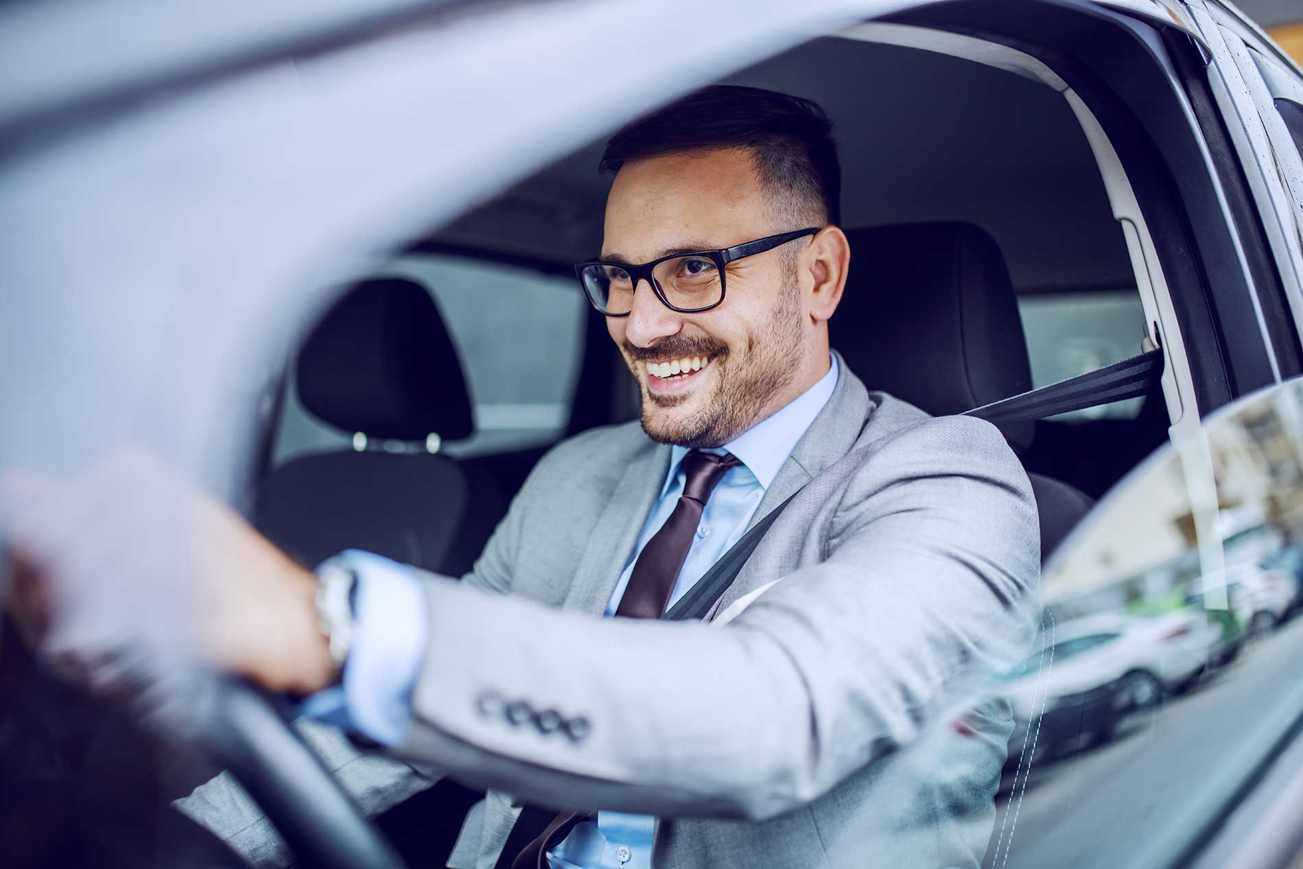 man driving his car on the road