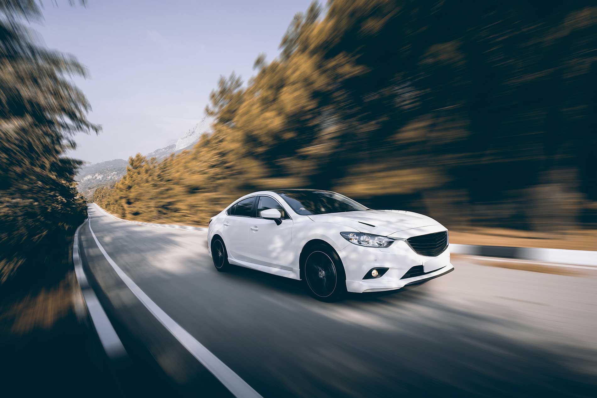 white car driving on the high way