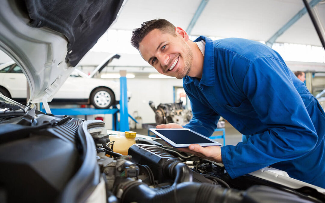 Mechanic using tablet on car