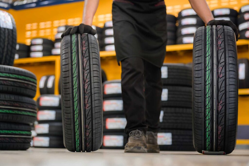 new tires being rolled out by a technician