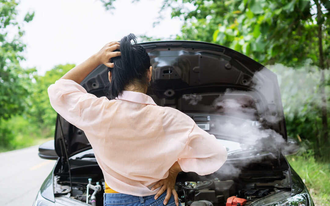 woman having problem with broken, overheat car